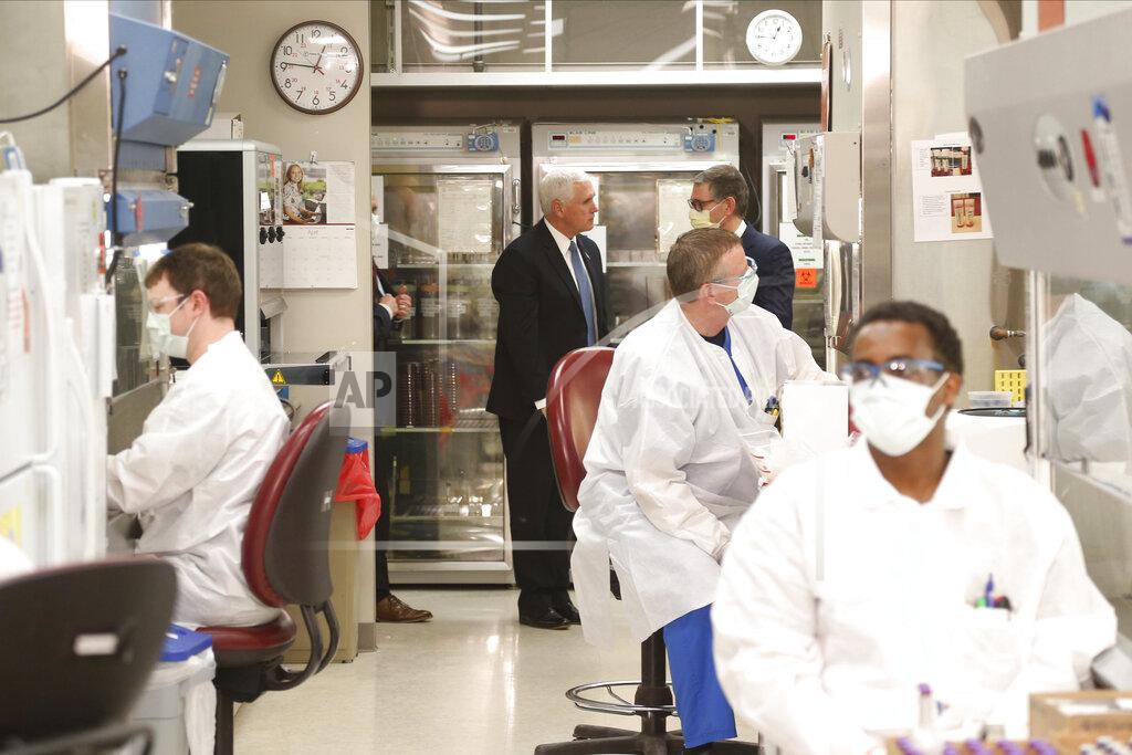 Jim Mone Vice President Mike Pence, center, visits the molecular testing lab at Mayo Clinic Tuesday, April 28, 2020, in Rochester, Minn., where he toured the facilities supporting COVID-19 research and treatment. (AP Photo/Jim Mone)