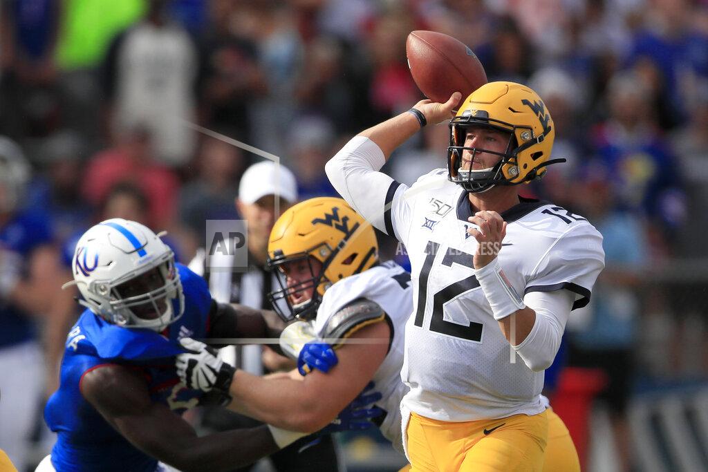 Orlin Wagner West Virginia quarterback Austin Kendall (12) passes to a teammate during the first half of an NCAA college football game against Kansas in Lawrence, Kan., Saturday, Sept. 21, 2019. Kendall passed for 202 yards in the game. West Virginia defeated Kansas 29-24. (AP Photo/Orlin Wagner)