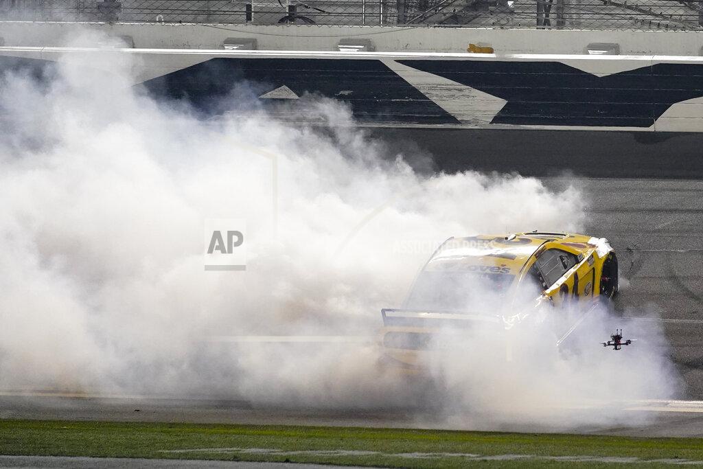 John Raoux Michael McDowell celebrates after winning the NASCAR Daytona 500 auto race at Daytona International Speedway, Monday, Feb. 15, 2021, in Daytona Beach, Fla. (AP Photo/John Raoux)