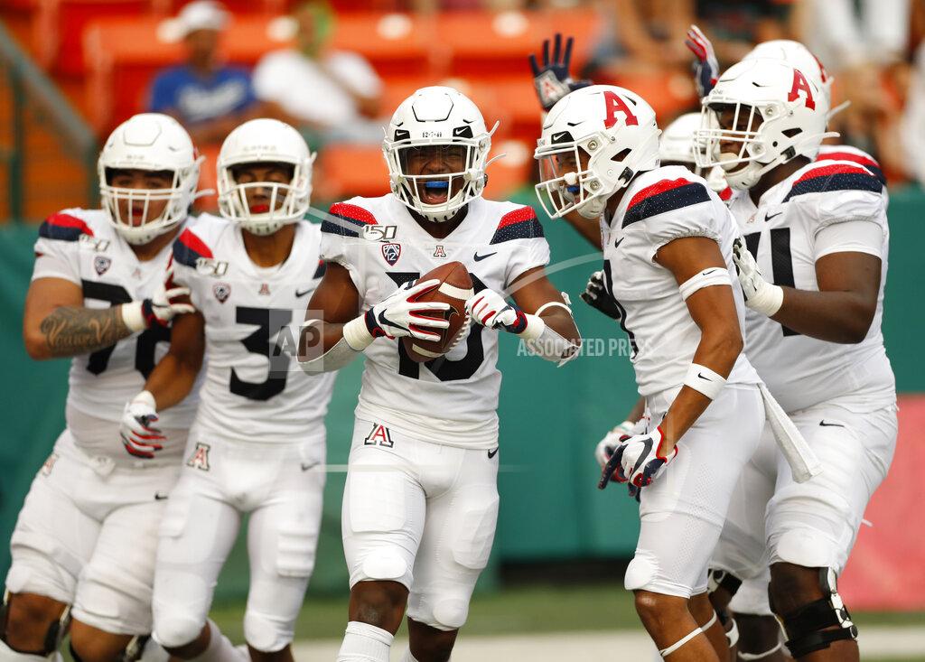 Marco Garcia Arizona wide receiver Jamarye Joiner (10) celebrates with teammates after scoring a second-quarter touchdown against Hawaii during an NCAA college football game Saturday, Aug. 24, 2019, in Honolulu. (AP Photo/Marco Garcia)