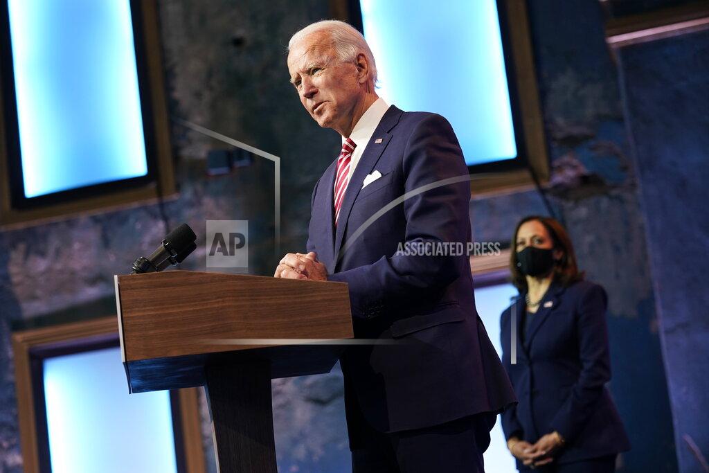 Andrew Harnik FILE - In this Nov. 16, 2020 file photo, President-elect Joe Biden, accompanied by Vice President-elect Kamala Harris, speaks about economic recovery at The Queen theater, in Wilmington, Del. Amid the new coronavirus pandemic that has devastated the continent for eight months, U.S. voters elected Biden for president, who has promised a more compassionate approach to immigration. (AP Photo/Andrew Harnik, File)