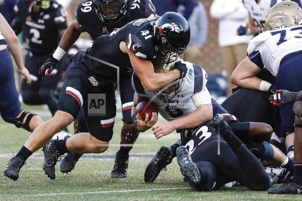 John Minchillo Navy wide receiver Zach Abey, center, is tackled by Cincinnati linebacker Joel Dublanko (41) and linebacker RJ Potts (23) in the second half of an NCAA college football game, Saturday, Nov. 3, 2018, in Cincinnati. (AP Photo/John Minchillo)