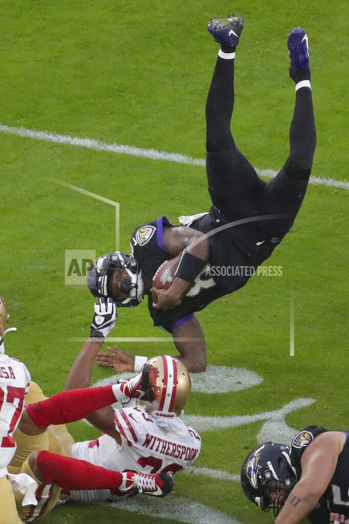 Julio Cortez Baltimore Ravens quarterback Lamar Jackson (8) flips after being tripped by San Francisco 49ers cornerback Ahkello Witherspoon (23) in the first half of an NFL football game, Sunday, Dec. 1, 2019, in Baltimore, Md. (AP Photo/Julio Cortez)