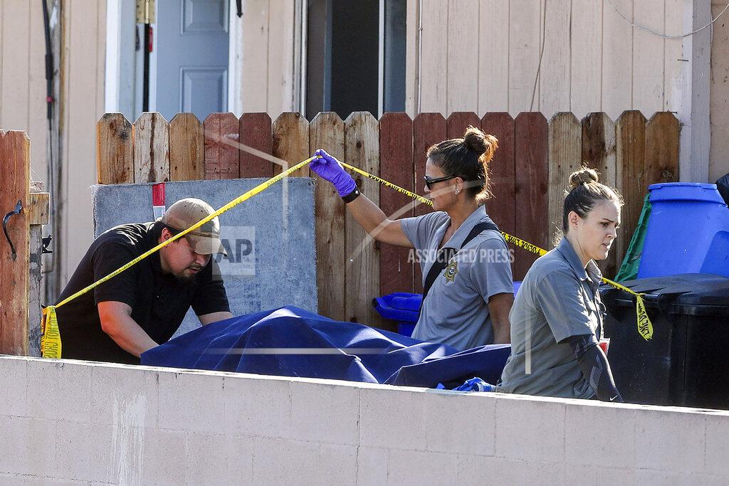 Hayne Palmour Iv FILE - In this Saturday, Nov. 16, 2019, file photo, a body is carried out on a gurney at the home where two adults and three children died from gunshot wounds during a domestic violence murder-suicide in the Paradise Hills area of San Diego. Detectives nationwide are grappling with changes the coronavirus has wrought on their investigations. Cold cases are getting colder, plainclothes investigators are digging out their dusty uniforms for patrol duty, and detectives are struggling to find new ways to connect with victims through thick masks. Even as police departments report major decreases in crime statistics thanks to stay-at-home orders, authorities say enough wrongdoing abounds to keep cops busy. And some detective work must still be in-person and hands-on, despite COVID-19. (Hayne Palmour IV/The San Diego Union-Tribune via AP, File)