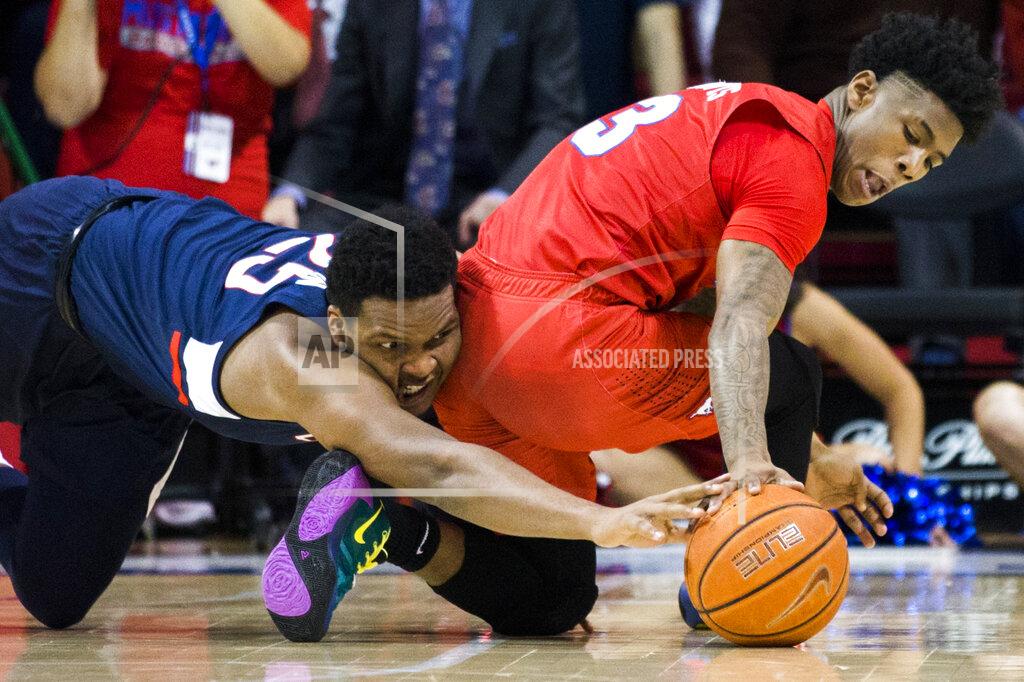 Ashley Landis SMU guard Kendric Davis (3) and Connecticut center Josh Carlton (25) reach for a loose ball during the first half of an NCAA college basketball game Wednesday, Feb. 12, 2020, in Dallas. (Ashley Landis/The Dallas Morning News via AP)