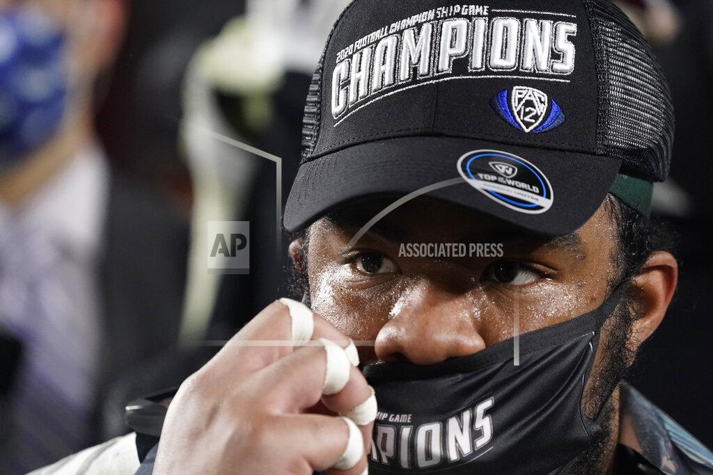 Ashley Landis Oregon offensive lineman George Moore (77) adjusts a championship facemark after winning the NCAA college football game for the Pac-12 Conference championship against Southern California Friday, Dec 18, 2020, in Los Angeles. Oregon won 31-24. (AP Photo/Ashley Landis)