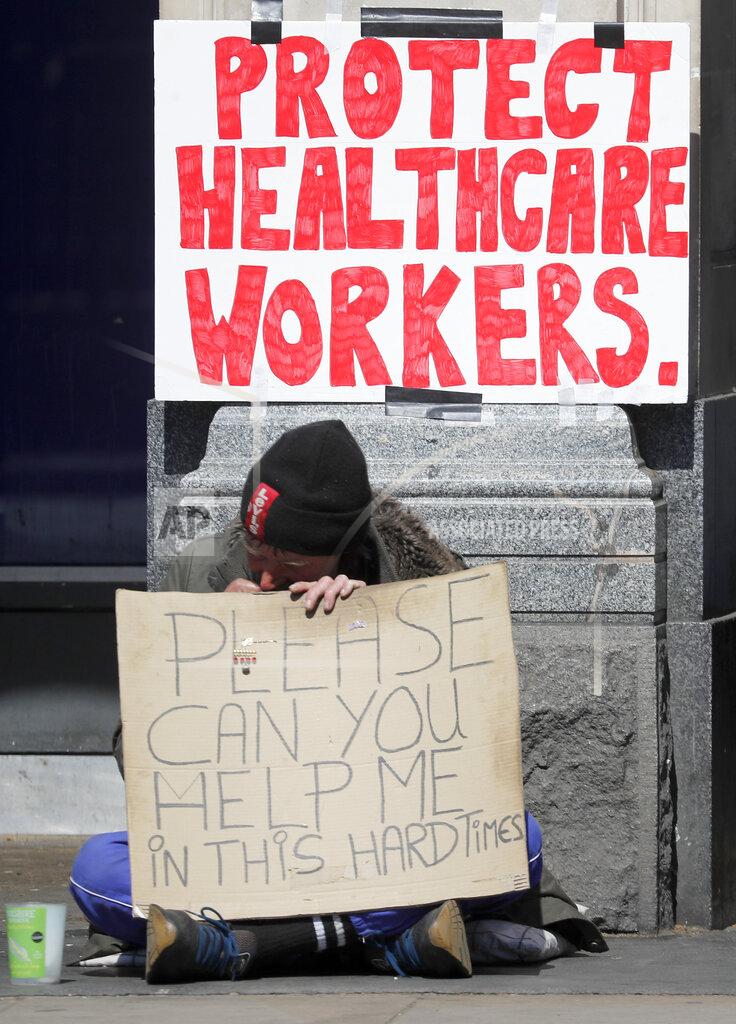 Frank Augstein A homeless man sits on the pavement in central London, Wednesday April 22, 2020 during the coronavirus lockdown. (AP Photo/Frank Augstein)