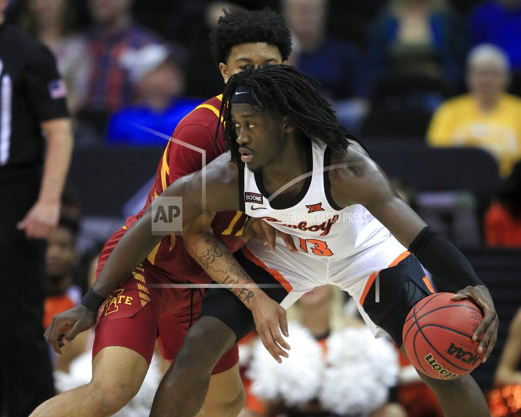 Orlin Wagner Oklahoma State guard Isaac Likekele (13) is covered by Iowa State guard Prentiss Nixon, left, during the second half of an NCAA college basketball game in the first round of the Big 12 men's basketball tournament in Kansas City, Kan., Wednesday, March 11, 2020. Oklahoma State defeated Iowa State 72-71. (AP Photo/Orlin Wagner)
