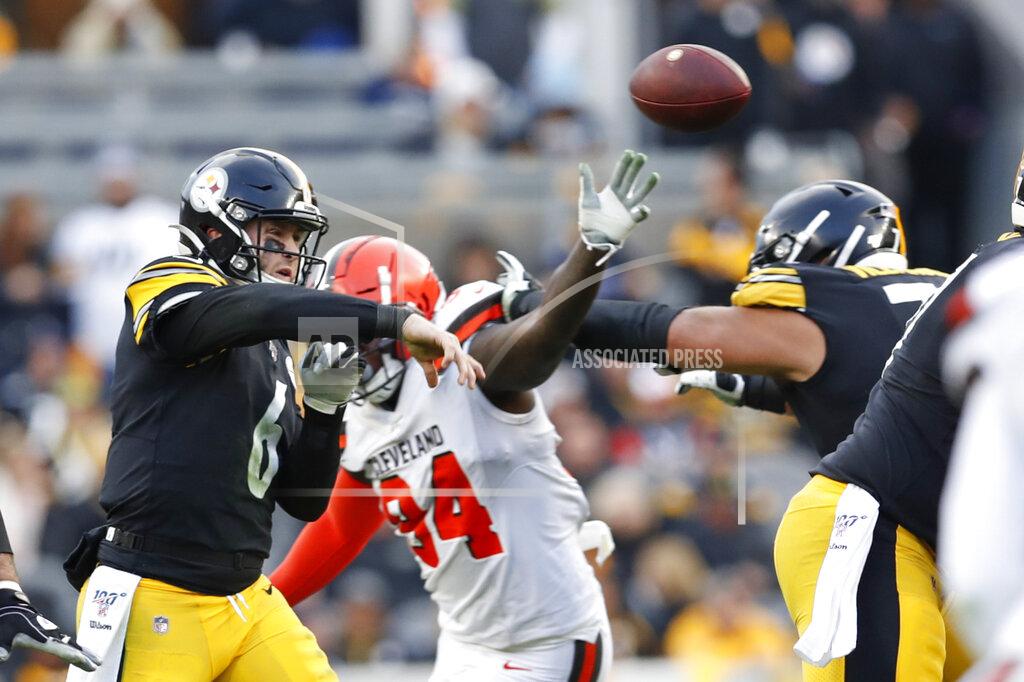 Don Wright Pittsburgh Steelers quarterback Devlin Hodges (6) passes the ball as he is pressured by Cleveland Browns defensive end Bryan Cox (94) in the second half of an NFL football, Sunday, Dec. 1, 2019, in Pittsburgh. (AP Photo/Don Wright)