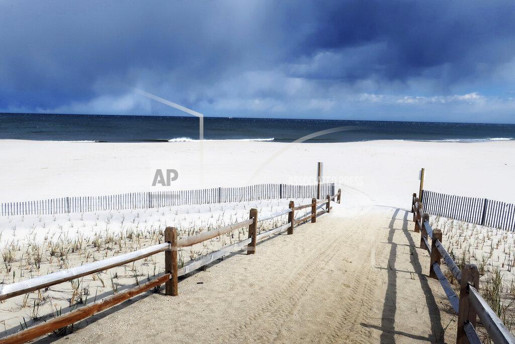Ted Shaffrey In this Friday, April 10, 2020, the beach is closed at Seaside Heights, N.J., during the coronavirus outbreak. For most people, the coronavirus causes mild or moderate symptoms, such as fever and cough that clear up in two to three weeks. For some, especially older adults and people with existing health problems, it can cause more severe illness, including pneumonia, or death. (AP Photo/Ted Shaffrey)