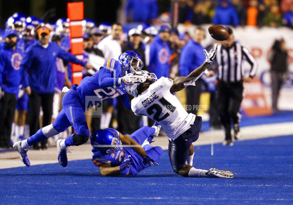 Steve Conner Utah State wide receiver Jalen Greene (21) reaches back for the ball as Boise State safety Tyreque Jones (21) grabs Greene's helmet to break up a reception attempt in the second of an NCAA college football game, Saturday, Nov. 24, 2018, in Boise, Idaho. Boise State won 33-24. (AP Photo/Steve Conner)
