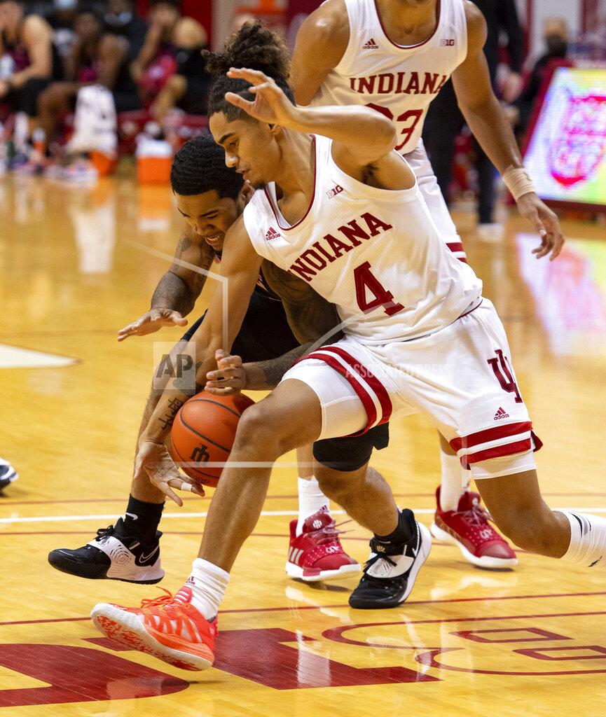 Doug Mcschooler Indiana guard Khristian Lander (4) steals the ball away from Penn State guard Sam Sessoms (3) during the first half of an NCAA college basketball game, Wednesday, Dec. 30, 2020, in Bloomington, Ind. (AP Photo/Doug McSchooler)