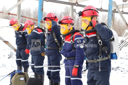 In this Russian Emergency Situations Ministry Thursday, Nov. 25, 2021 photo, rescuers prepare to work at a fire scene at a coal mine near the Siberian city of Kemerovo, about 3,000 kilometres (1,900 miles) east of Moscow, Russia,. Russian authorities say a fire at a coal mine in Siberia has killed nine people and injured 44 others. Dozens of others are still trapped. A Russian news agency says the blaze took place in the Kemerovo region in southwestern Siberia. (Russian Ministry for Emergency Situations photo via AP)