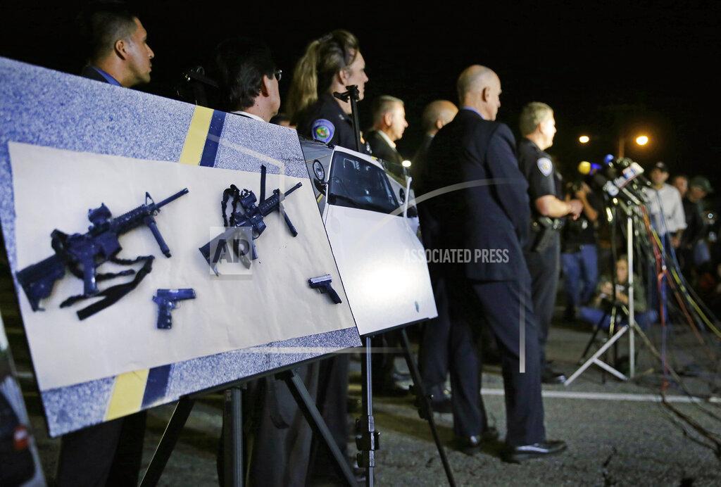 Chris Carlson FILE - In this Thursday, Dec. 3, 2015, file photo, police crime photos of assault rifles and handguns are displayed during a news conference near the site of a mass shooting in San Bernardino, Calif. A husband and wife on Dec. 2, 2015, dressed for battle and carrying assault rifles and handguns, opened fire on a holiday banquet for his co-workers, killing at least 14 people and seriously wounding more than a dozen others in a precision assault, authorities said. A federal judge on Friday, June 4, 2021, has overturned California's three-decade-old ban on assault weapons, ruling that it violates the constitutional right to bear arms. (AP Photo/Chris Carlson, File)
