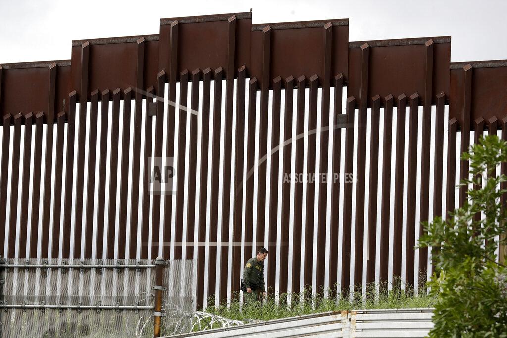 Gregory Bull FILE - In this March 18, 2020, file photo, a Border Patrol agent walks along a border wall separating Tijuana, Mexico, from San Diego, in San Diego. U.S. authorities wield extraordinary power available in public health emergencies, like the coronavirus pandemic, to expel Mexicans and many Central Americans immediately to Mexico and waive immigration laws that include rights to seek asylum. (AP Photo/Gregory Bull, File)