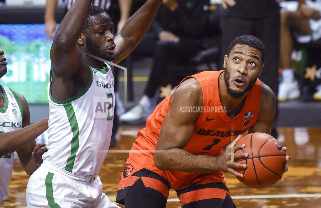 Andy Nelson Oregon State guard Jarod Lucas (2) looks to shoot over Oregon forward Eugene Omoruyi during the first half of an NCAA college basketball game Saturday, Jan. 23, 2021, in Eugene, Ore. (AP Photo/Andy Nelson)