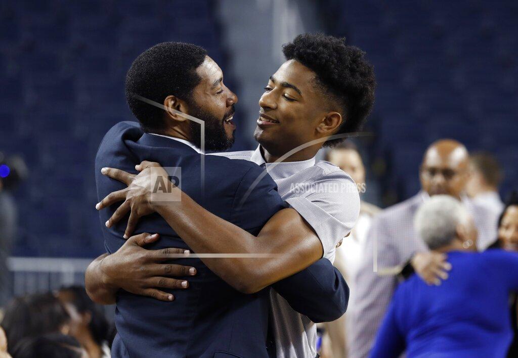 Carlos Osorio Retired NBA and former Michigan player Jimmy King, left, embraces Jace Howard before Jace's father Juwan is introduced as Michigan's new men's basketball coach, Thursday, May 30, 2019 in Ann Arbor, Mich. (AP Photo/Carlos Osorio)