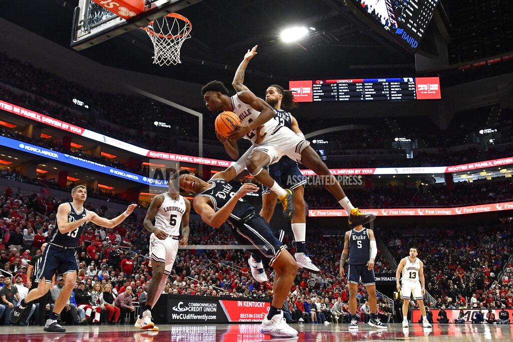 Timothy D. Easley Louisville forward Jae'Lyn Withers (24) drives to the basket against Duke forward Wendell Moore Jr. (0) during the second half of an NCAA college basketball game in Louisville, Ky., Saturday, Jan. 29, 2022. Duke won 74-65. (AP Photo/Timothy D. Easley)