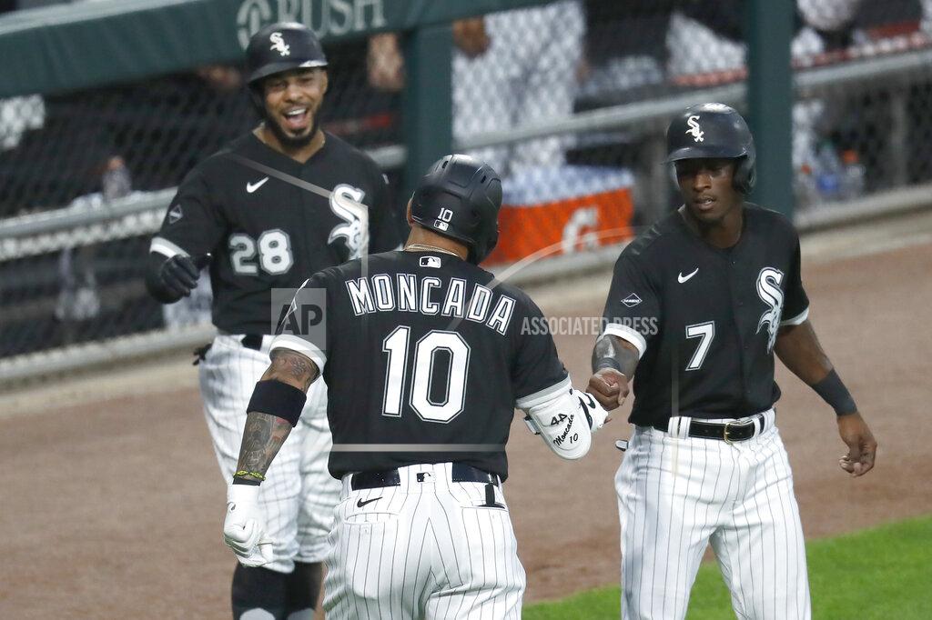 Charles Rex Arbogast Chicago White Sox's Yoan Moncada (10) is greeted outside the dugout by Leury Garcia (28) and Tim Anderson, after Moncada's three-run home run off Minnesota Twins starting pitcher Jose Berrios during the second inning of a baseball game Friday, July 24, 2020, in Chicago. (AP Photo/Charles Rex Arbogast)