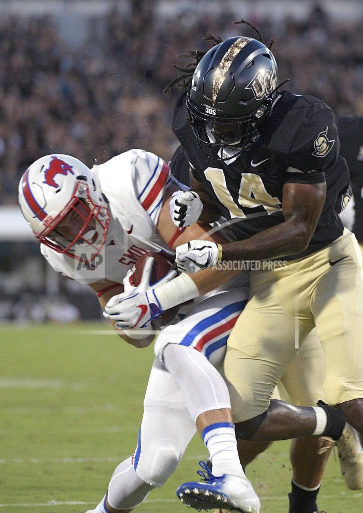 Phelan M. Ebenhack SMU tight end Ben Redding, left, is tackled by Central Florida defensive back Nevelle Clarke (14) after catching a pass during the first half of an NCAA college football game Saturday, Oct. 6, 2018, in Orlando, Fla. (AP Photo/Phelan M. Ebenhack)