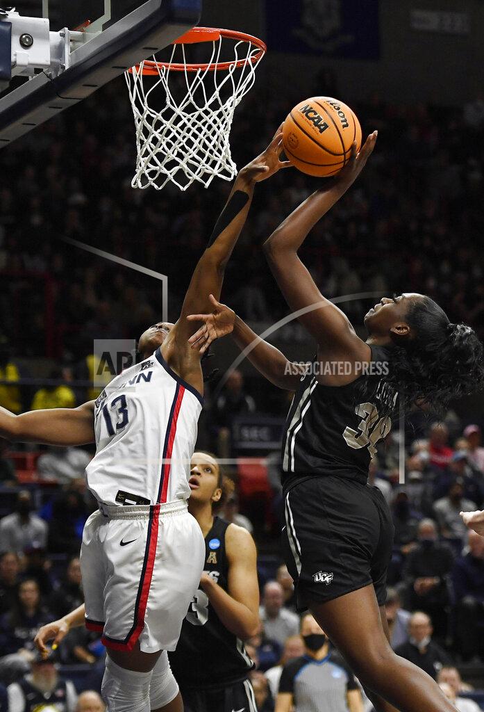 Jessica Hill Connecticut's Christyn Williams, left, blocks a shot by Central Florida's Neila Luma during the first half of a second-round college basketball game in the NCAA tournament, Monday, March 21, 2022, in Storrs, Conn. (AP Photo/Jessica Hill)