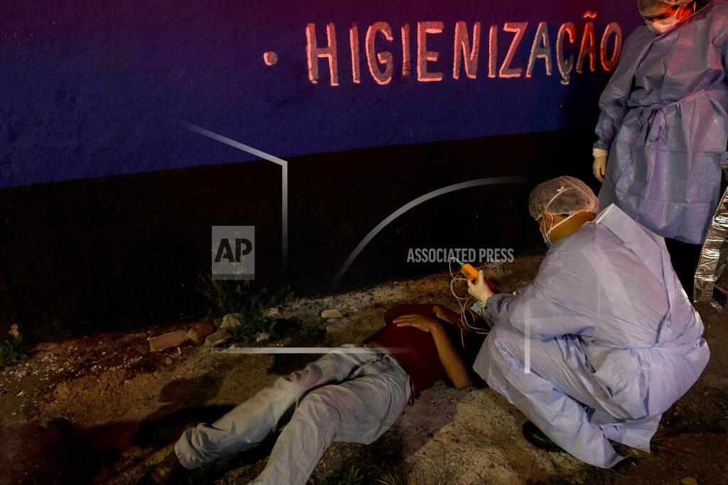 Marcelo Chello FILE - In this May 8, 2021 file photo, a man suspected of having COVID-19 who collapsed on a street is treated by Mobile Emergency Care Service staff, in Sao Paulo, Brazil. Nearly 2,000 people are dying of COVID-19 each day of in Brazil, a tally surpassed only by India. (AP Photo/Marcelo Chello, File)