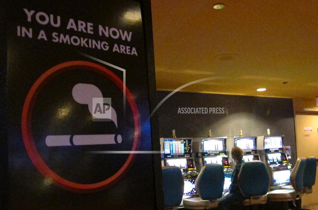 Wayne Parry This March 9, 2016 photo shows a sign denoting a smoking section of the casino floor at the Tropicana casino in Atlantic City, N.J. On Thursday, April 15, 2021, health advocates, smoking opponents and some New Jersey lawmakers called for the state's temporary ban on casino smoking, imposed last year due to the coronavirus pandemic, be made permanent once the outbreak ends. (AP Photo/Wayne Parry)