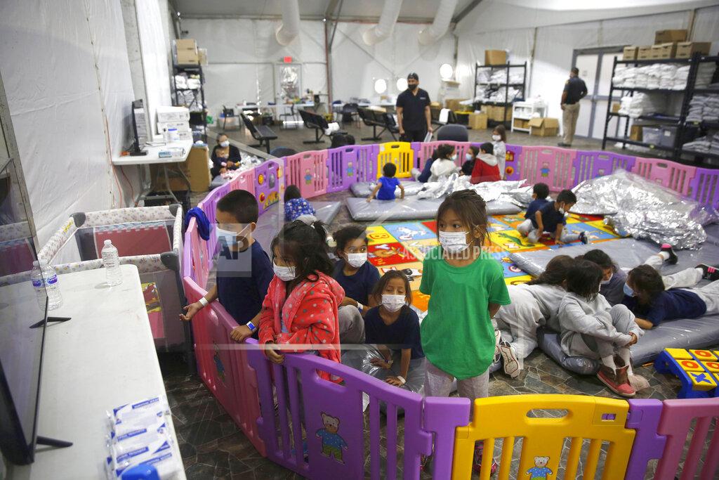 Dario Lopez-Mills FILE - In this March 30, 2021, file photo, young unaccompanied migrants, from ages 3 to 9, watch television inside a playpen at the U.S. Customs and Border Protection facility, the main detention center for unaccompanied children in the Rio Grande Valley, in Donna, Texas. U.S. authorities say they picked up nearly 19,000 children traveling alone across the Mexican border in March. It's the largest monthly number ever recorded and a major test for President Joe Biden as he reverses many of his predecessor's hardline immigration tactics. (AP Photo/Dario Lopez-Mills, Pool, File)