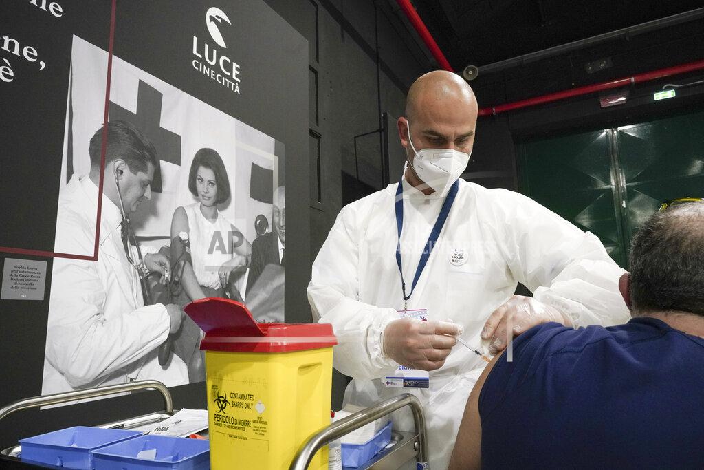 Andrew Medichini A man receives a dose of the Pfizer COVID-19 vaccine, at a vaccination center set at Rome's Cinecitta' film studios, Tuesday, April 20, 2021. (AP Photo/Andrew Medichini)