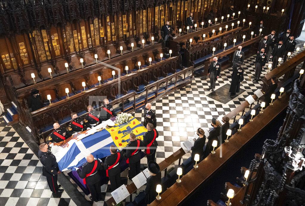 Dominic Lipinski Queen Elizabeth watches as pallbearers carry the coffin of the Duke of Edinburgh during his funeral, at St George's Chapel in Windsor Castle, Windsor, England, Saturday April 17, 2021. Prince Philip died April 9 at the age of 99 after 73 years of marriage to Britain's Queen Elizabeth II. (Dominic Lipinski/Pool via AP)
