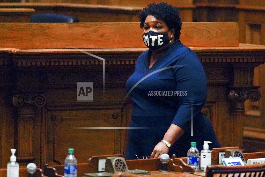 John Bazemore FILE - In this Monday, Dec. 14, 2020, file photo, Democrat Stacey Abrams walks on Senate floor before of members of Georgia's Electoral College cast their votes at the state Capitol in Atlanta. In a new interview with The Associated Press, voting rights advocate Abrams discussed a new state law that tightens some Georgia voting rules after Democrats carried the state in the 2020 elections. (AP Photo/John Bazemore, Pool, File)