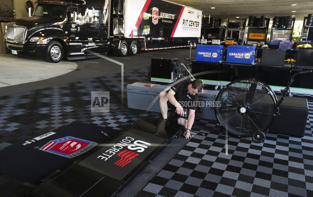 Dirk Shadd Kirby What, the front end mechanic for driver Marco Andretti, works to pack up the paddock area at the IndyCar Grand Prix of St. Petersburg, Friday, March 13, 2020 in St. Petersburg. NASCAR and IndyCar have postponed their weekend schedules at Atlanta Motor Speedway and St. Petersburg, due to concerns over the COVID-19 pandemic. (Dirk Shadd/Tampa Bay Times via AP)