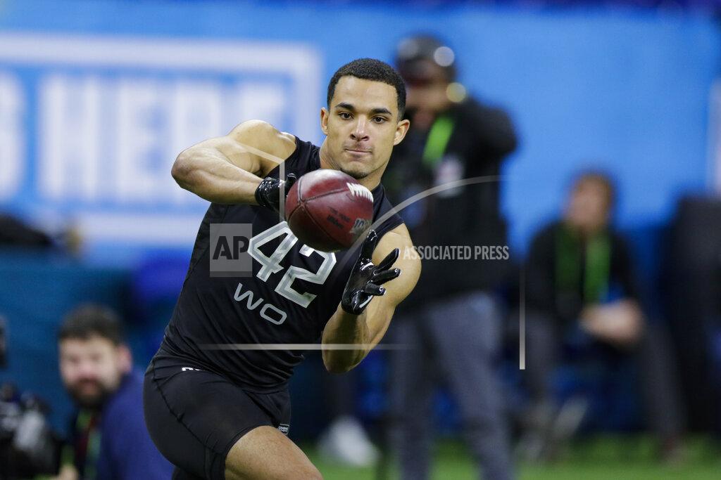 FILE - In this Thursday, Feb. 27, 2020, file photo, Navy wide receiver Malcolm Perry runs a drill at the NFL football scouting combine in Indianapolis. Perry, drafted by the Miami Dolphins, will be able to turn pro in 2020 thanks to a policy change initiated by President Donald Trump. New guidelines issued in November 2019 allow service academy graduates to seek delaying their military commitment in order to play pro sports, and Perry's request for a waiver is expected to be granted. (AP Photo/Michael Conroy, File)
