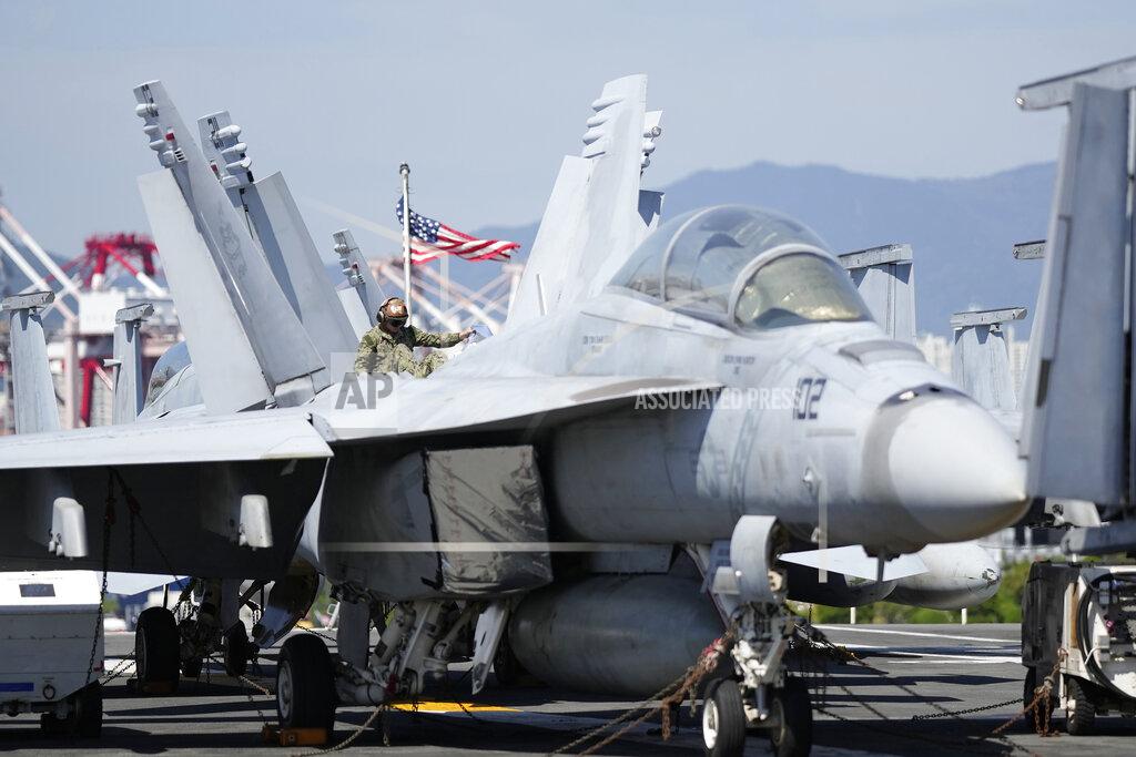 Lee Jin-Man U.S. soldier checks the F/A-18 Super Hornet fighter jet on the deck of the aircraft carrier USS Ronald Reagan in Busan, South Korea, Friday, Sept. 23, 2022. The nuclear-powered aircraft carrier arrived in Busan port on Friday ahead of the two countries' joint military exercise that aims to show their strength against growing North Korean threats. (AP Photo/Lee Jin-man)