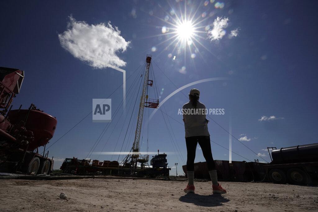 Eric Gay Ashley Williams Watt watches as a workover rig is used to help replug one of the abandoned wells at her ranch, Friday, July 9, 2021, near Crane, Texas. Some of her wells are leaking chemicals such as benzene, a known carcinogen, into fields and drinking water. (AP Photo/Eric Gay)