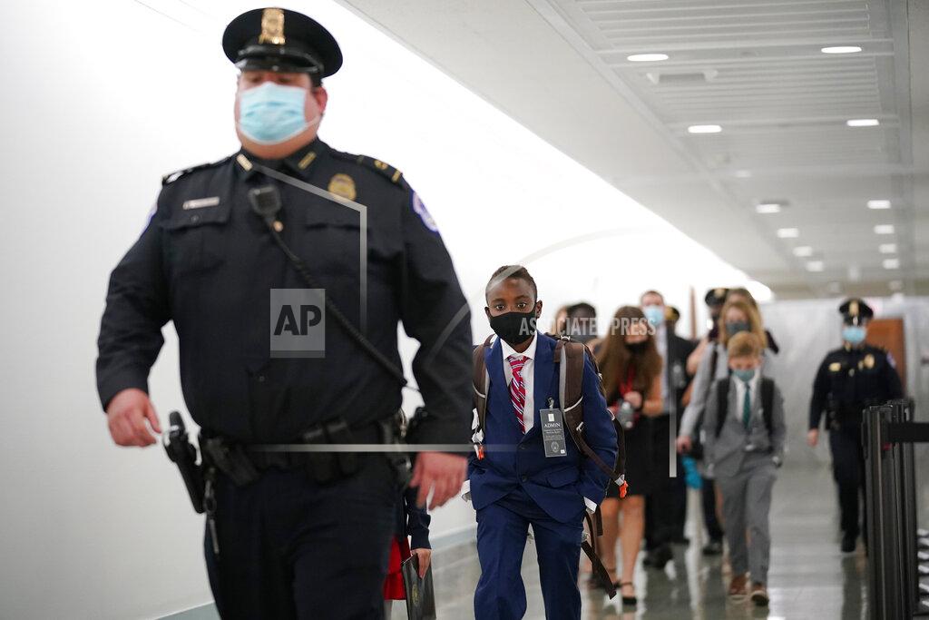 J. Scott Applewhite The children of Supreme Court nominee Amy Coney Barrett walk on Capitol Hill at the end of day one of her confirmation hearing before the Senate Judiciary Committee, Monday, Oct. 12, 2020 on Capitol Hill in Washington. (AP Photo/J. Scott Applewhite)