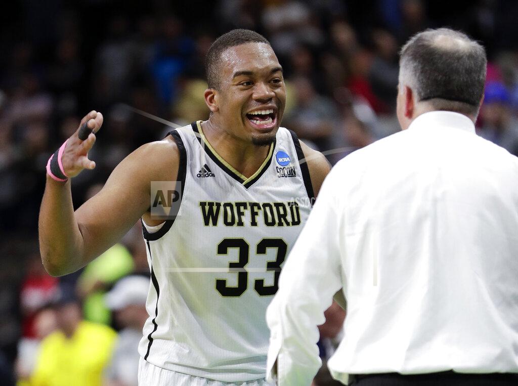 John Raoux Wofford's Cameron Jackson (33) greets coach Mike Young as he comes off the court during the final moments against Seton Hall during a first-round game in the NCAA men’s college basketball tournament in Jacksonville, Fla., Thursday, March 21, 2019. (AP Photo/John Raoux)