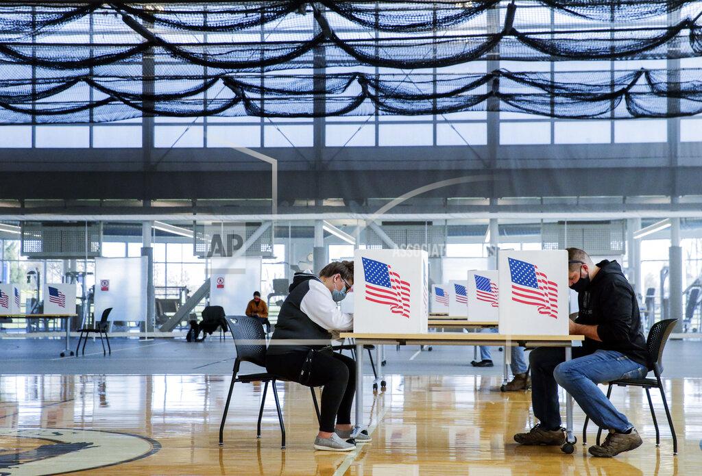 Jim Slosiarek FILE - In this Nov. 3, 2020, file photo, Brooklyn Landt, left, and Eric Vos fill in their ballots during voting at the Kirkwood Community College Recreation Center in the 2020 election in Cedar Rapids, Iowa. In addition to their nationwide efforts to restrict voting access, Republican lawmakers in some key states are seeking greater control over the local mechanics of elections, from voter registration to certifying results. (Jim Slosiarek/The Gazette via AP, File)
