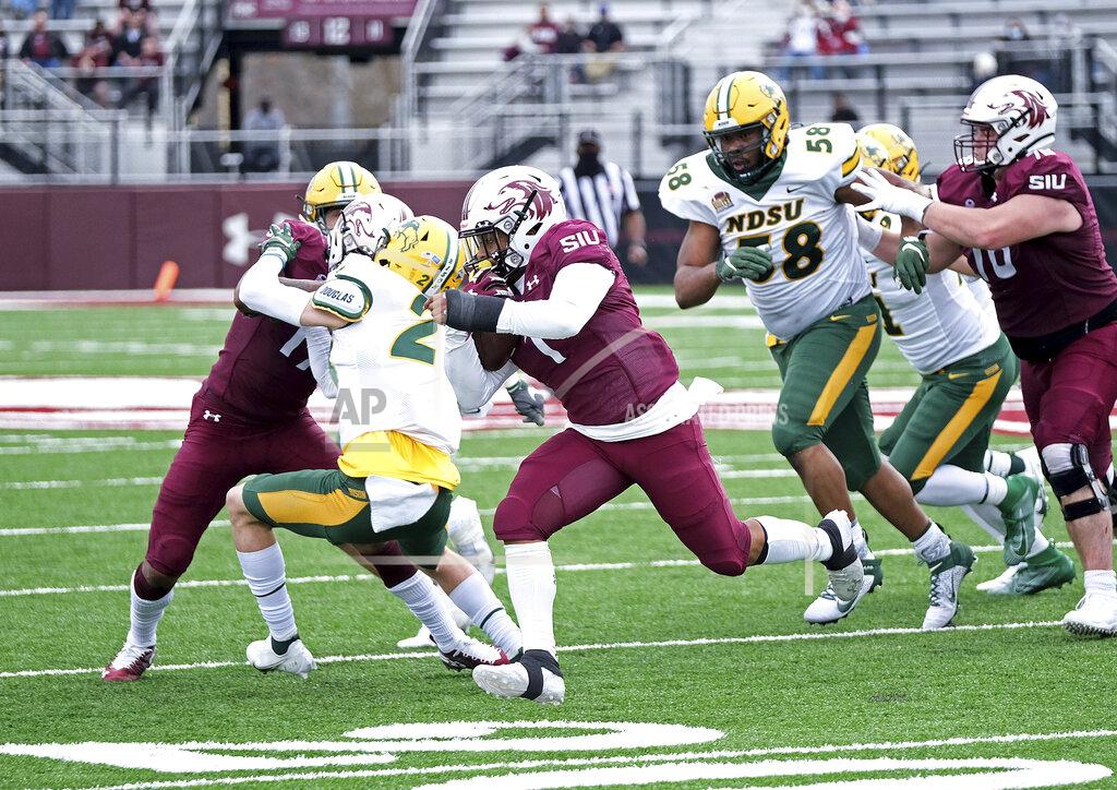 Byron Hetzler Southern Illinois running back Romeir Elliott (1) looks for running room next to North Dakota State free safety Dawson Weber (2) during the fourth quarter of an NCAA college football game Saturday, Feb. 29, 2021, in Carbondale, Ill. (Byron Hetzler/The Southern Illinoisan via AP)