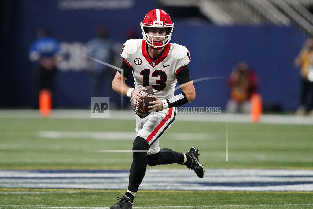 Brynn Anderson Georgia quarterback Stetson Bennett (13) runs the ball out of the pocket against Alabama during the second half of the Southeastern Conference championship NCAA college football game, Saturday, Dec. 4, 2021, in Atlanta. (AP Photo/Brynn Anderson)