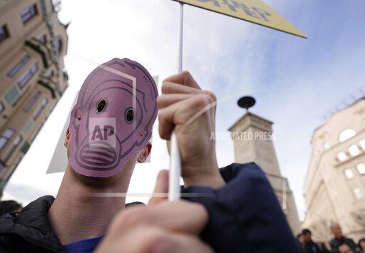 A man holds a banner during a protest for clean air in Belgrade, Serbia, Sunday, Nov. 28, 2021. Several thousand people have rallied in Belgrade for another environmental protest, a day after demonstrators blocked bridges and roads on several locations in Serbia, and scuffled with riot police who deployed to stop them. (AP Photo/Darko Vojinovic)