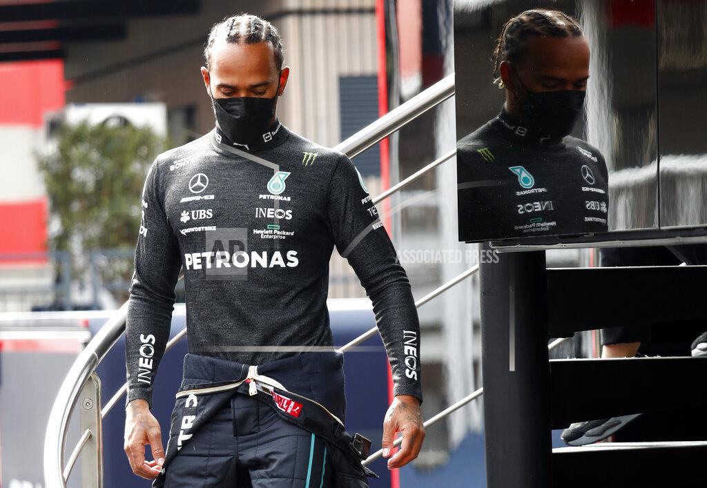 Joan Monfort Mercedes driver Lewis Hamilton of Britain walks down stairs during a Formula One pre-season testing session at the Catalunya racetrack in Montmelo, just outside of Barcelona, Spain, Friday, Feb. 25, 2022. (AP Photo/Joan Monfort)