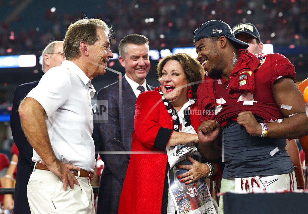 Wilfredo Lee Alabama running back Damien Harris (34) and Terry Saban, laugh with Alabama head coach Nick Saban, during the Orange Bowl NCAA college football game trophy presentation, Sunday, Dec. 30, 2018, in Miami Gardens, Fla. Alabama defeated Oklahoma 45-34. (AP Photo/Wilfredo Lee)
