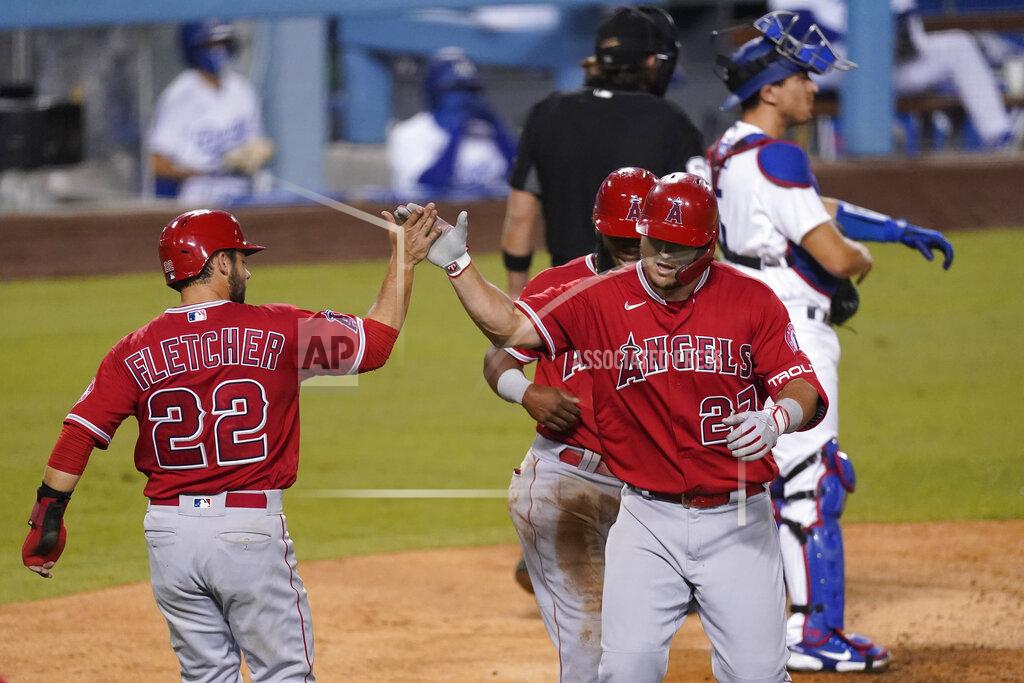 Ashley Landis Los Angeles Angels' Mike Trout, right, celebrates a three-run home run with David Fletcher, left, and Luis Rengifo, who scored, during the third inning of the team's baseball game against the Los Angeles Dodgers on Friday, Sept. 25, 2020, in Los Angeles. (AP Photo/Ashley Landis)