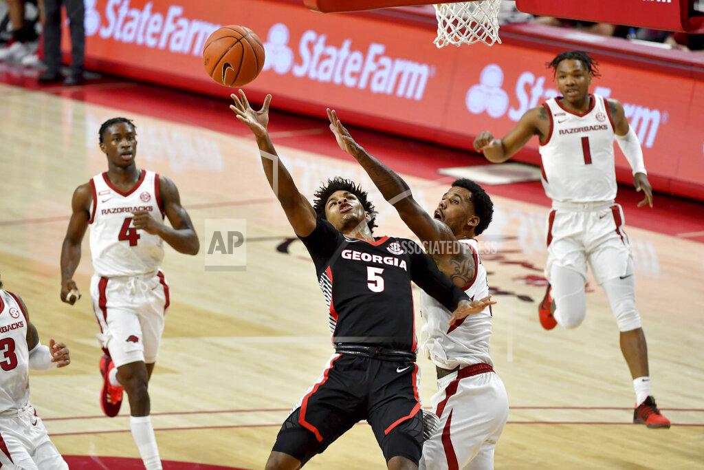 Michael Woods Georgia's Justin Kier (5) tries to drive past Arkansas defender Vance Jackson Jr. (2) during the first half of an NCAA college basketball game Saturday, Jan. 9, 2021, in Fayetteville, Ark. (AP Photo/Michael Woods)