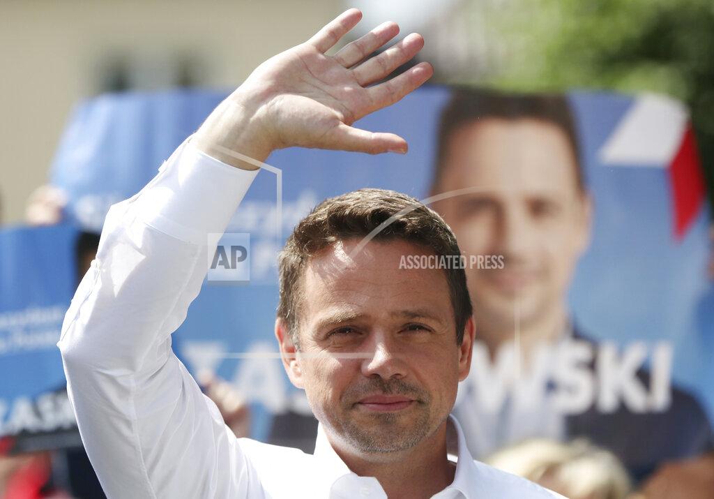 Czarek Sokolowski In this Thursday, July 9, 2020 photo Rafal Trzaskowski, contender in Poland's tight presidential election runoff on Sunday, July 12, 2020, waves during a rally in Raciaz, Poland. Trzaskowski is running against incumbent conservative president, Andrzej Duda, who has backing from the ruling party. Opinion polls suggest the election may be decided by a small number of votes. (AP Photo/Czarek Sokolowski)