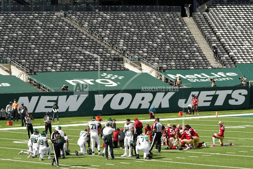 Corey Sipkin FILE - In this Sunday, Sept. 20, 2020, file photo, players gather around an injured person during the first half of an NFL football game between the New York Jets and the San Francisco 49ers at a nearly empty MetLife Stadium, Sunday, Sept. 20, 2020, in East Rutherford, N.J. New Jersey Gov. Phil Murphy conditionally vetoed a bill on Monday, Oct. 19, 2020, that would have expanded charitable groups' ability to sell raffle tickets online based around sporting events, determining it was too close to internet gambling. Because the coronavirus pandemic has drastically reduced or even eliminated in-person attendance, some legislators proposed letting people buy tickets to such raffles over the internet, regardless of whether they were in a stadium or not. (AP Photo/Corey Sipkin, File)
