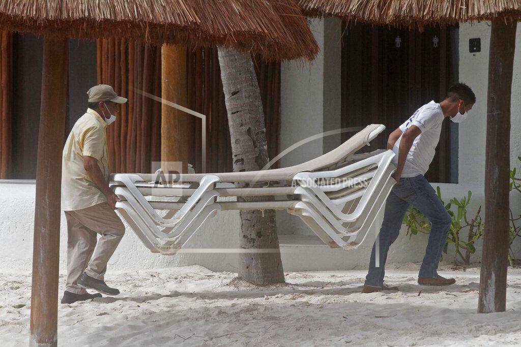 Tomas Stargardter Beach hotel workers store chairs inside as they prepare for the arrival of Tropical Storm Zeta in Playa del Carmen, Mexico, Monday, Oct. 26, 2020. A strengthening Tropical Storm Zeta is expected to become a hurricane Monday as it heads toward the eastern end of Mexico's resort-dotted Yucatan Peninsula and then likely move on for a possible landfall on the central U.S. Gulf Coast at midweek. (AP Photo/Tomas Stargardter)