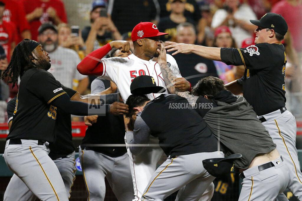 Sam Greene Cincinnati Reds relief pitcher Amir Garrett (50) looks to throw a punch as he is held back by a number of Pittsburgh Pirates players during a brawl in the ninth inning of a baseball game in Cincinnati, July 30, 2019. (Sam Greene/The Cincinnati Enquirer via AP)
