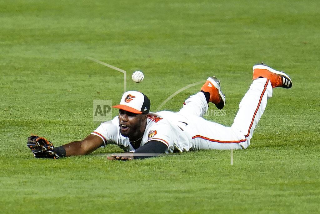 Julio Cortez Baltimore Orioles center fielder Cedric Mullins is unable to make a diving catch on a ball hit by Boston Red Sox's Christian Vazquez during the second inning of a baseball game, Thursday, Aug. 20, 2020, in Baltimore. (AP Photo/Julio Cortez)